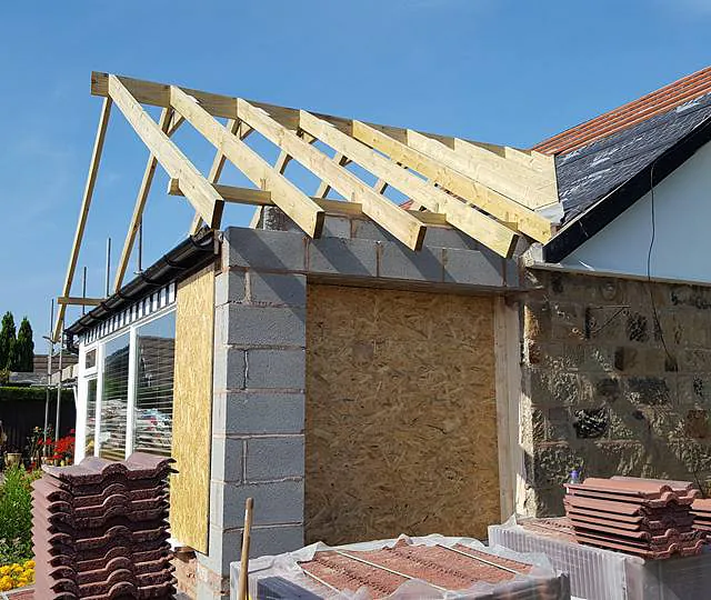 A new roof being added to an home extension