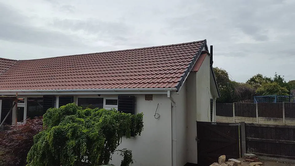 Side view of completed roofing work by our team